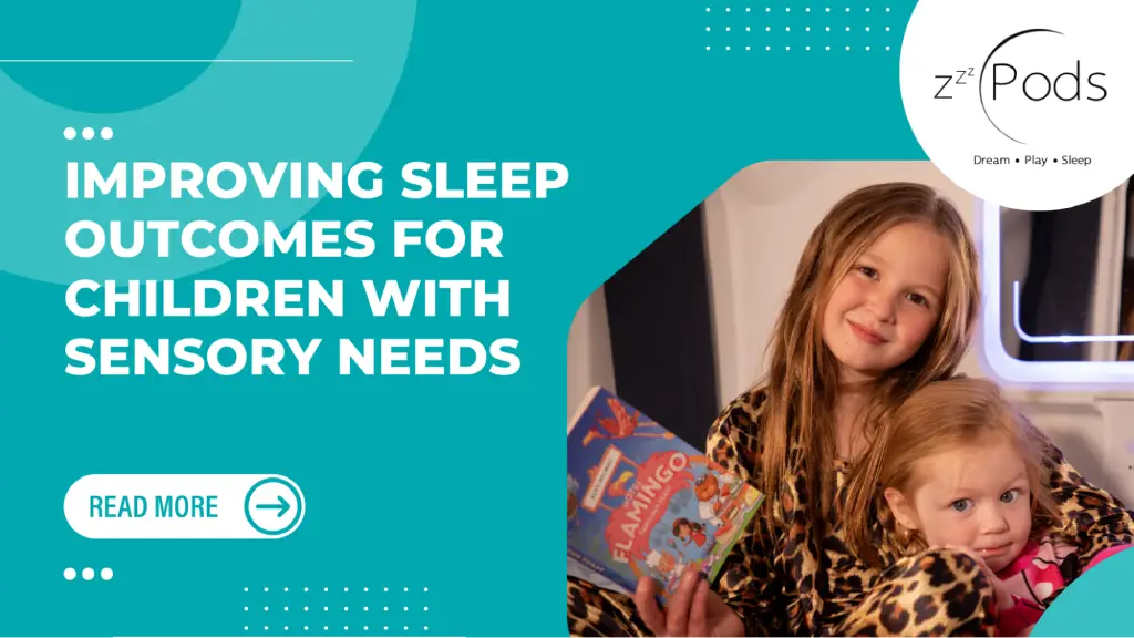 Two young girls in pajamas reading a book, promoting better sleep outcomes for children with sensory needs.
